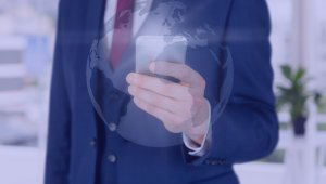 Close-up of hand with smartphone and world map